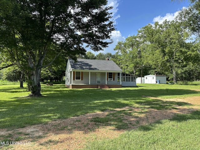 232 Renfroe Rd, Canton, MS 39046 - view of front facade featuring a front lawn, a shed, a porch, and roof with shingles