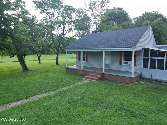 232 Renfroe Rd, Canton, MS 39046 - view of front of house featuring a chimney, a shingled roof, covered porch, a front lawn, and cooling unit