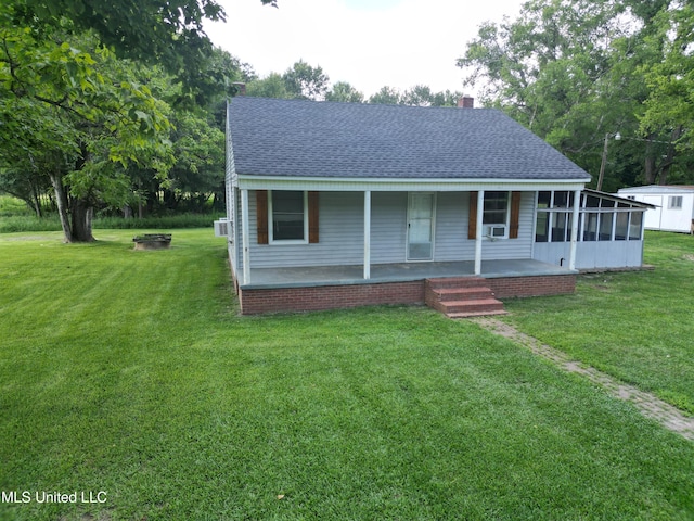 232 Renfroe Rd, Canton, MS 39046 - view of front of property with a shingled roof, a chimney, a front yard, and a porch