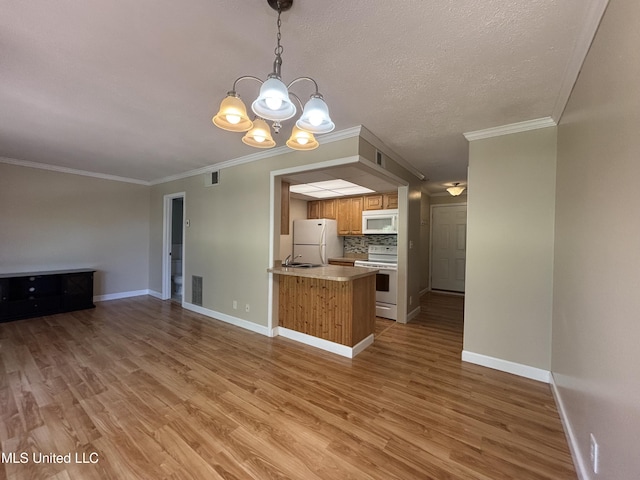 248 Lakeside Villa Unit J, Diamondhead, MS 39525 - kitchen with light wood-style floors, a notable chandelier, backsplash, white appliances, and open floor plan