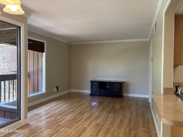 248 Lakeside Villa Unit J, Diamondhead, MS 39525 - unfurnished living room with light wood-style floors, crown molding, and baseboards
