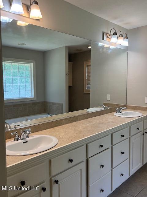 104 Blackstone Cir, Brandon, MS 39047 - full bathroom with double vanity, a garden tub, and tile patterned flooring