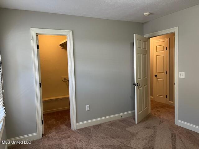 104 Blackstone Cir, Brandon, MS 39047 - unfurnished bedroom featuring carpet, a spacious closet, and a closet