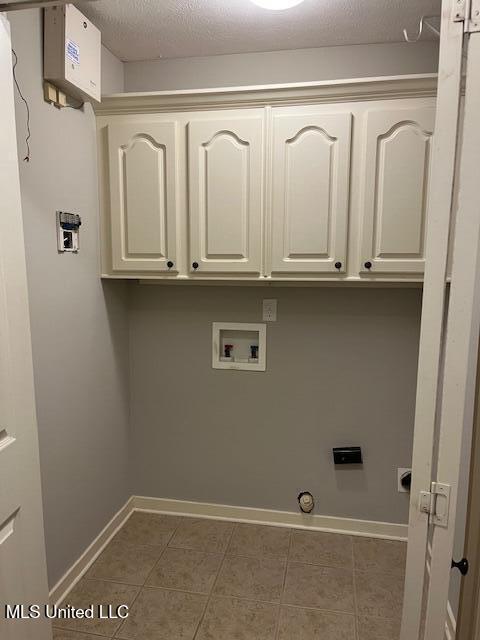 104 Blackstone Cir, Brandon, MS 39047 - laundry area with cabinet space, washer hookup, tile patterned floors, and hookup for a gas dryer