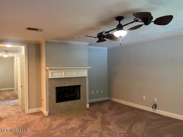 104 Blackstone Cir, Brandon, MS 39047 - unfurnished living room with carpet floors, crown molding, ceiling fan, and a tiled fireplace