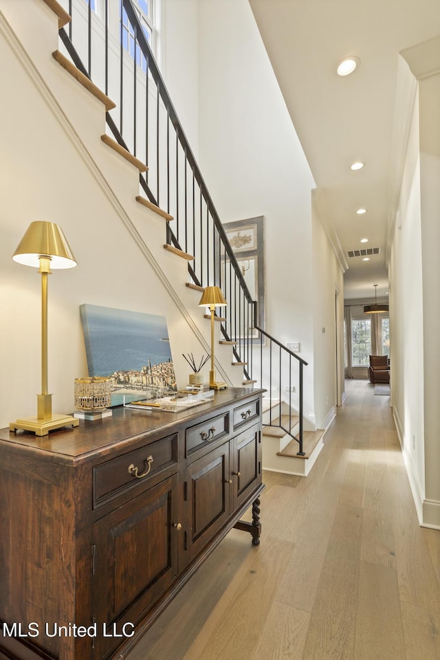 interior space featuring light hardwood / wood-style flooring and a high ceiling