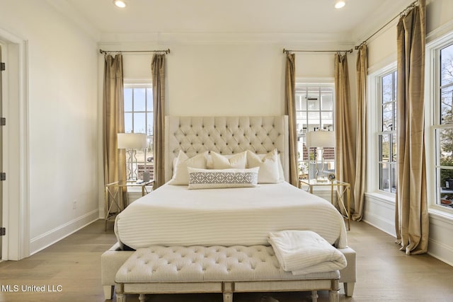 bedroom featuring hardwood / wood-style flooring and ornamental molding