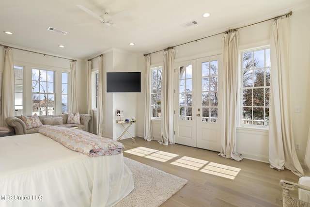 bedroom featuring access to outside, french doors, ceiling fan, and light wood-type flooring