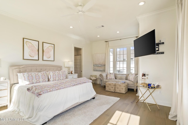 bedroom with crown molding, light hardwood / wood-style flooring, and ceiling fan