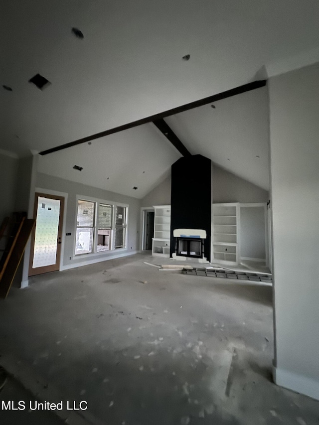 unfurnished living room featuring lofted ceiling with beams