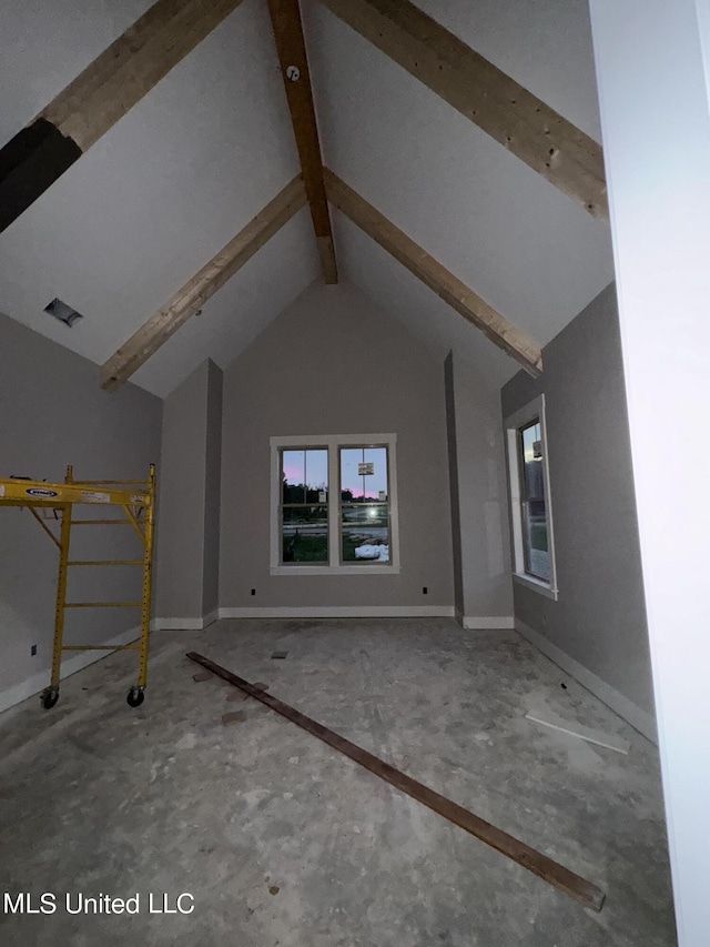 interior space with beamed ceiling, baseboards, and high vaulted ceiling