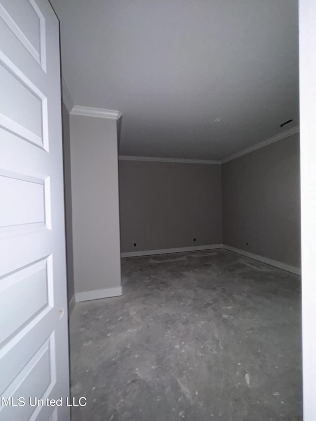 interior space featuring baseboards, unfinished concrete flooring, and ornamental molding