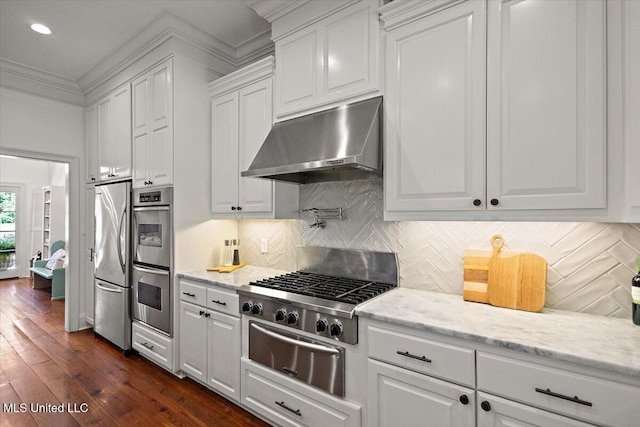 2003 Canterbury Pl W, Brandon, MS 39042 - kitchen featuring under cabinet range hood, appliances with stainless steel finishes, a warming drawer, white cabinetry, and crown molding