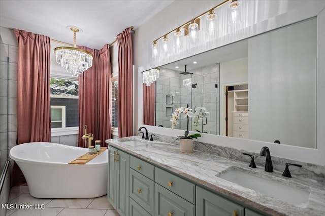 2003 Canterbury Pl W, Brandon, MS 39042 - bathroom featuring a stall shower, a chandelier, a soaking tub, double vanity, and a walk in closet