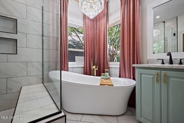 2003 Canterbury Pl W, Brandon, MS 39042 - full bath featuring a chandelier, a freestanding tub, vanity, and marble finish floors