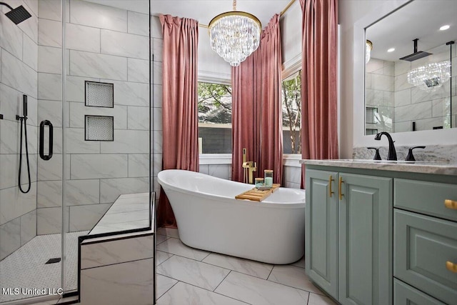 2003 Canterbury Pl W, Brandon, MS 39042 - bathroom with a stall shower, vanity, a soaking tub, marble finish floors, and a chandelier