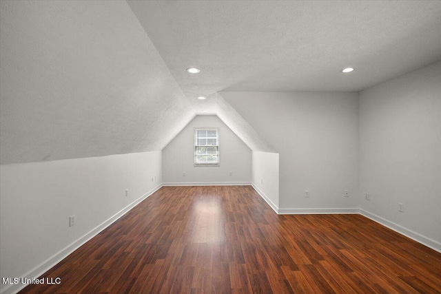 2003 Canterbury Pl W, Brandon, MS 39042 - additional living space featuring lofted ceiling, baseboards, a textured ceiling, dark wood-style flooring, and recessed lighting