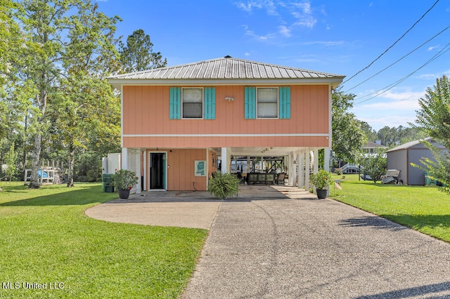 view of front of property with a front lawn and a carport