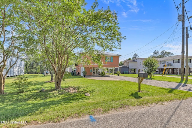 view of front facade featuring a carport and a front lawn