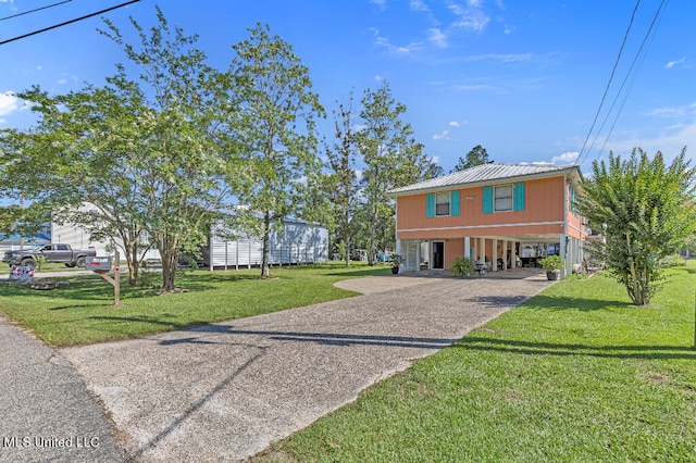 view of front of house with a front lawn and a carport