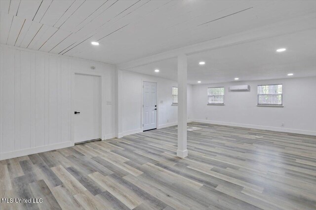 4560 Meadowridge Dr, Jackson, MS 39206 - basement with wood finished floors, a wall mounted air conditioner, baseboards, and recessed lighting