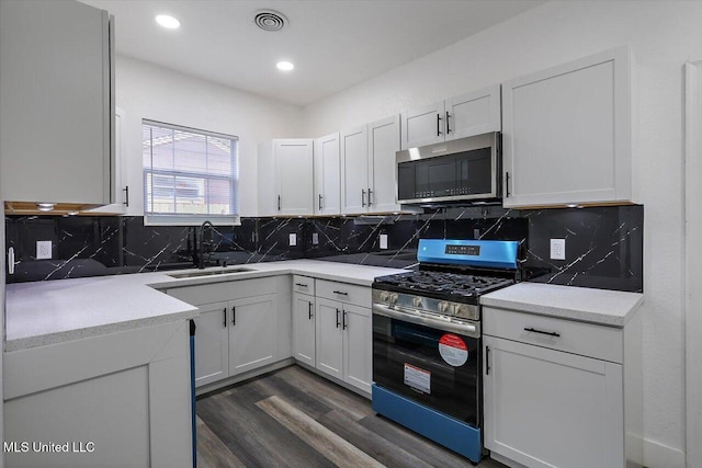 4560 Meadowridge Dr, Jackson, MS 39206 - kitchen featuring white cabinets, visible vents, light countertops, a sink, and stainless steel appliances