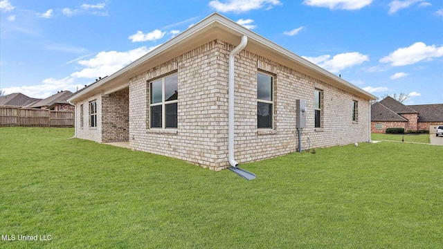 view of side of property featuring a yard