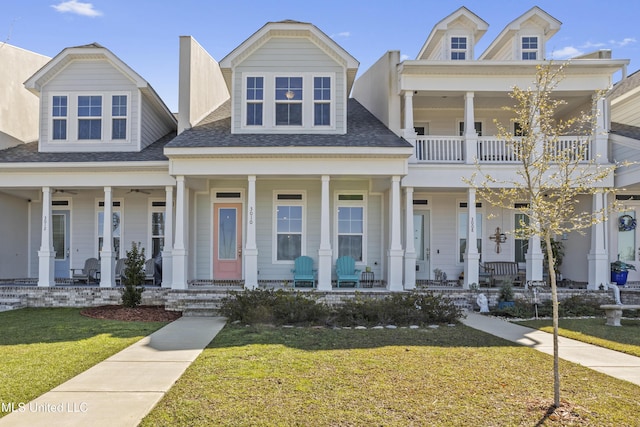 greek revival inspired property featuring a porch and a front yard