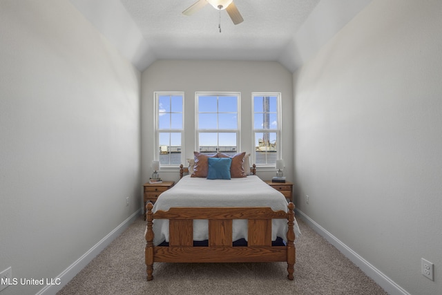 bedroom with lofted ceiling, carpet, and baseboards