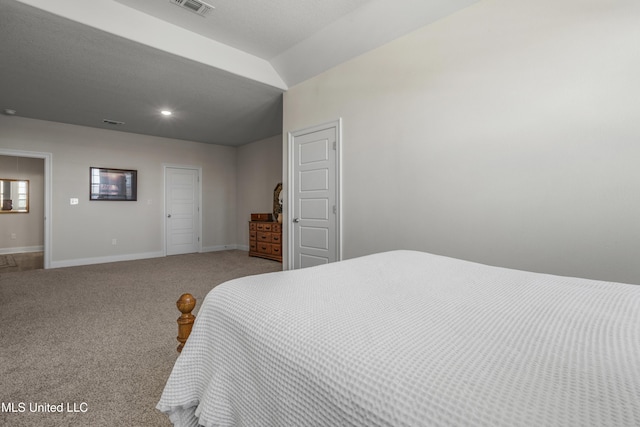 bedroom with carpet floors, visible vents, vaulted ceiling, and baseboards