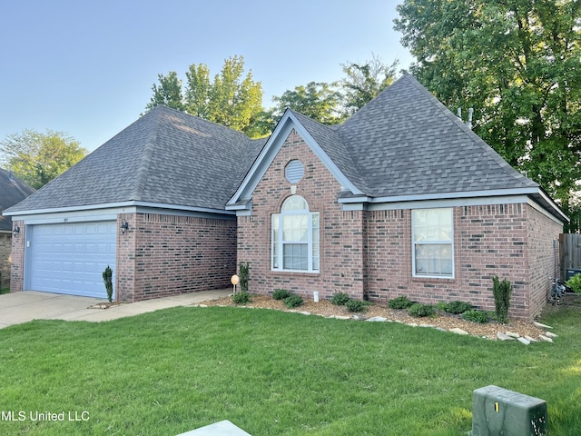 view of front of home featuring roof with shingles, brick siding, and a garage
