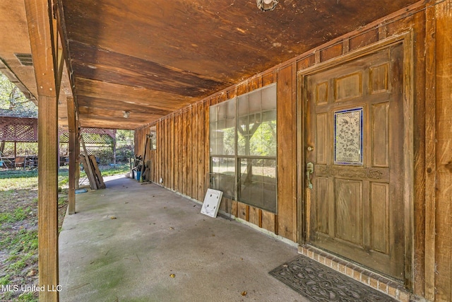 misc room featuring a wealth of natural light, wood ceiling, and concrete flooring