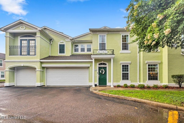 2252 Beach Dr Unit 206, Gulfport, MS 39507 - view of front of home with stucco siding, a balcony, a garage, and driveway