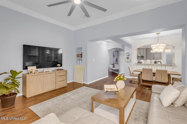 2252 Beach Dr Unit 206, Gulfport, MS 39507 - living room with arched walkways, ceiling fan, wood finished floors, crown molding, and a chandelier