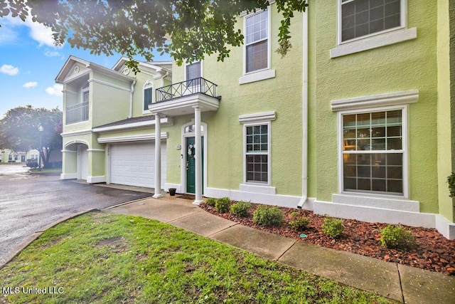 2252 Beach Dr Unit 206, Gulfport, MS 39507 - multi unit property featuring a balcony, stucco siding, driveway, and a garage