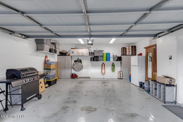 2252 Beach Dr Unit 206, Gulfport, MS 39507 - garage with freestanding refrigerator and a garage door opener