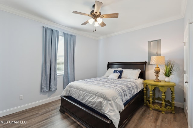 bedroom featuring dark hardwood / wood-style flooring, ceiling fan, and crown molding