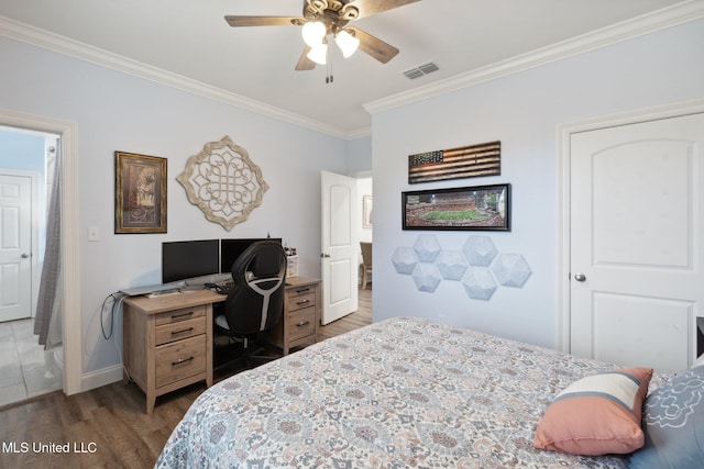 bedroom featuring ornamental molding, dark wood-type flooring, and ceiling fan