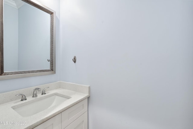 bathroom with ornamental molding and vanity