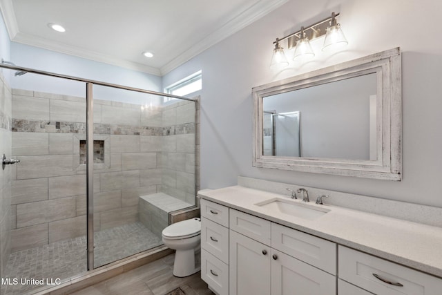 bathroom featuring a shower with door, crown molding, vanity, hardwood / wood-style floors, and toilet