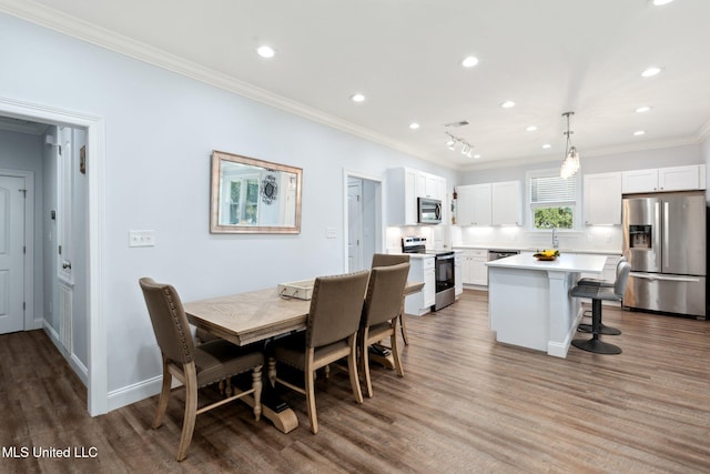 dining room featuring hardwood / wood-style flooring and ornamental molding