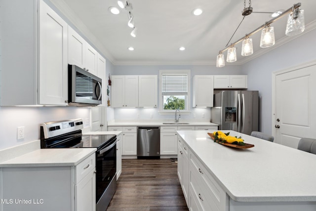 kitchen with stainless steel appliances, crown molding, white cabinets, pendant lighting, and dark hardwood / wood-style flooring