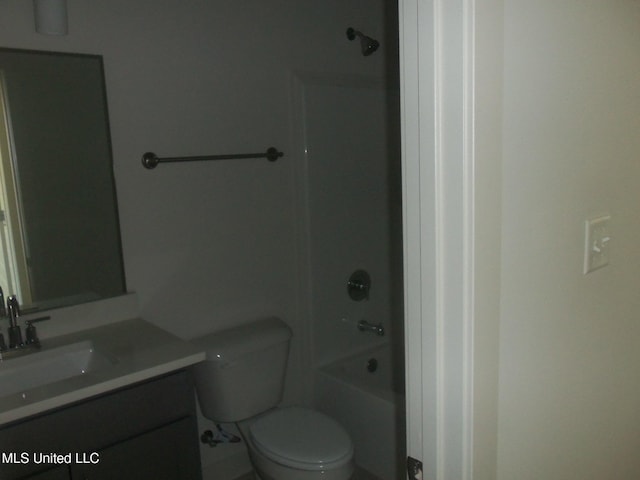bathroom featuring toilet, vanity, and shower / washtub combination