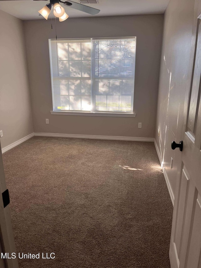 empty room featuring carpet flooring and ceiling fan