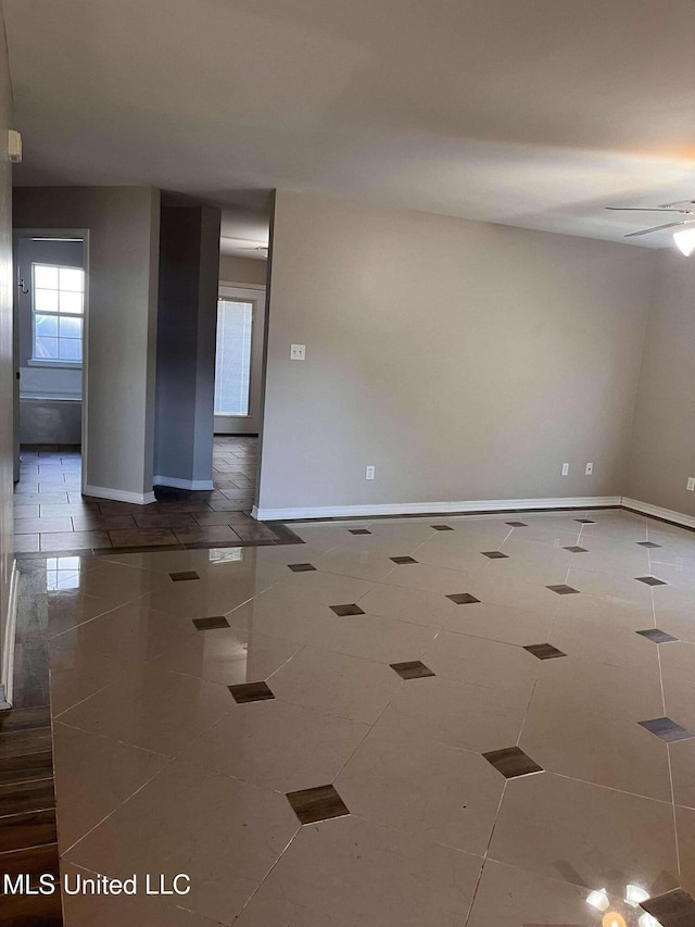 tiled empty room with ceiling fan