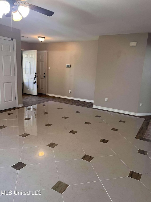 spare room with hardwood / wood-style flooring and ceiling fan