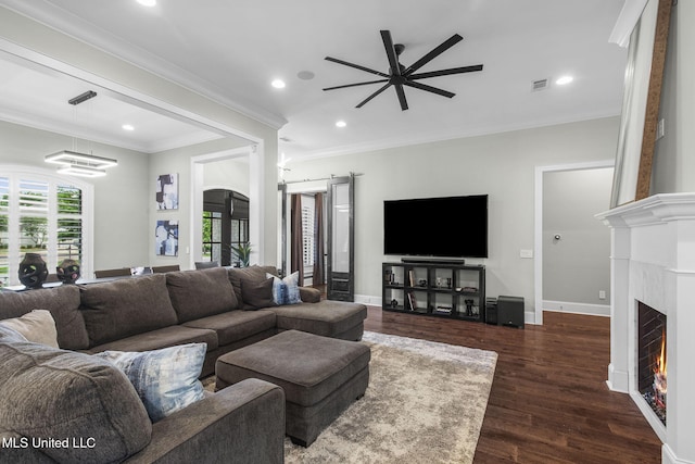 302 Covington Cv, Madison, MS 39110 - living area featuring ceiling fan, dark wood-type flooring, crown molding, recessed lighting, and a warm lit fireplace