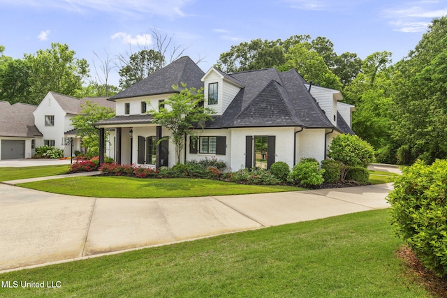 302 Covington Cv, Madison, MS 39110 - view of front of home featuring a front lawn, roof with shingles, concrete driveway, brick siding, and a garage