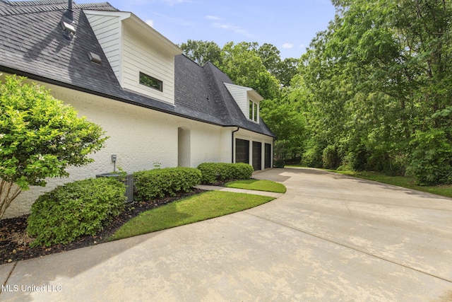302 Covington Cv, Madison, MS 39110 - view of property exterior with driveway, a garage, and roof with shingles