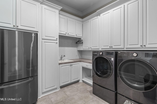 302 Covington Cv, Madison, MS 39110 - laundry room featuring independent washer and dryer, light tile patterned floors, cabinet space, and ornamental molding